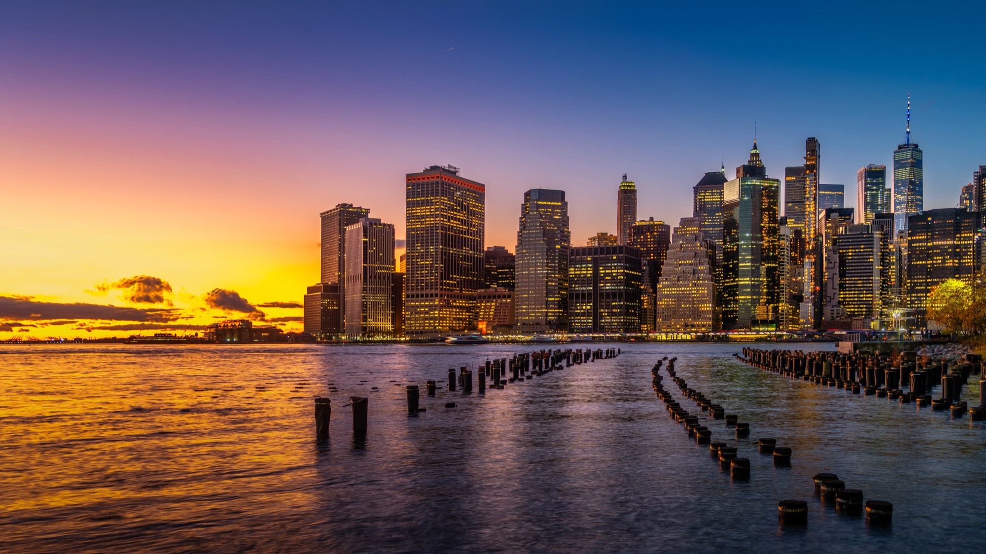 Lower Manhattan skyline at sunset over the East River